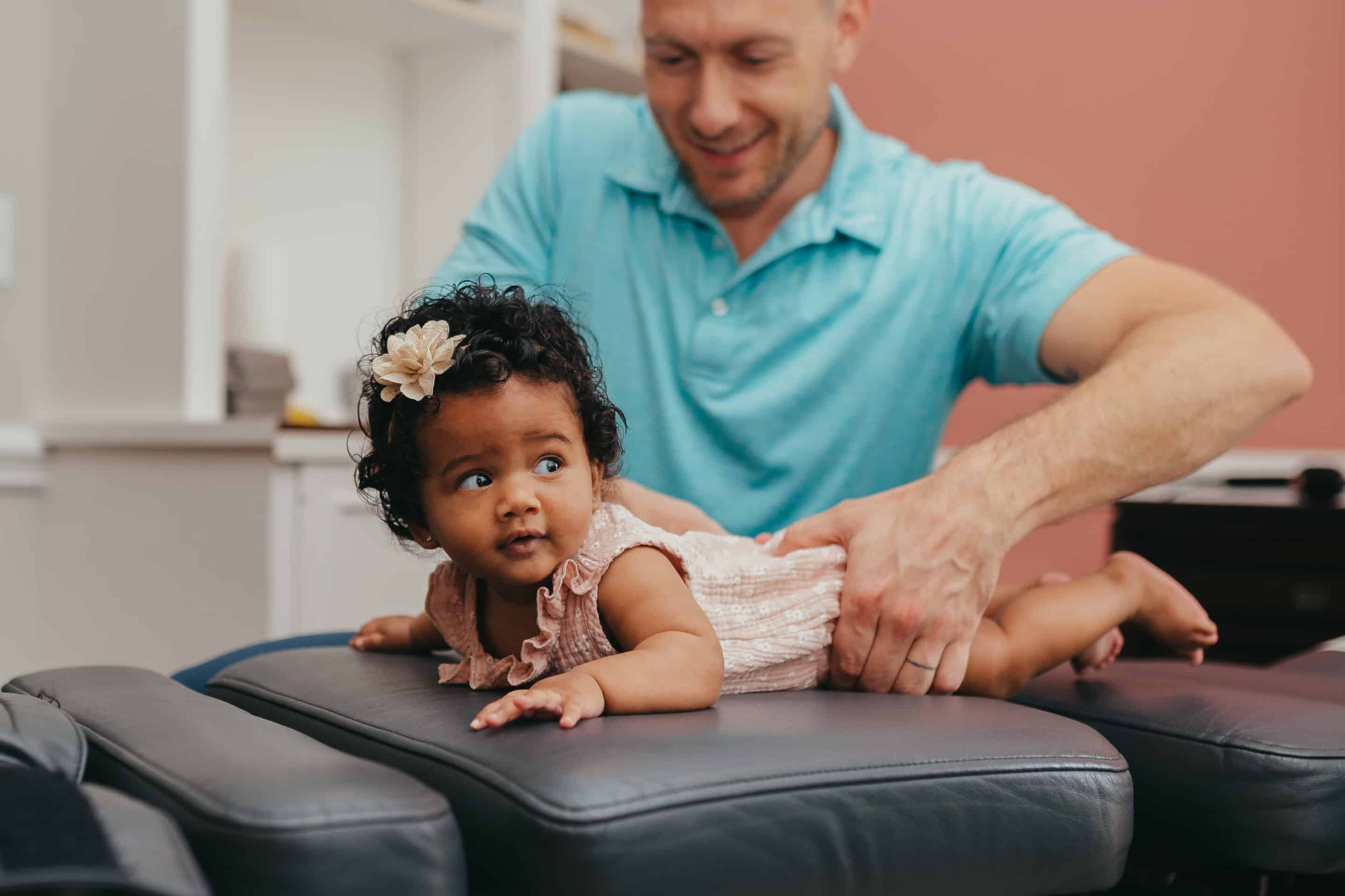 Dr. Pries with infant being adjusted Pediatric & Family Chiropractor Directory | PX Docs